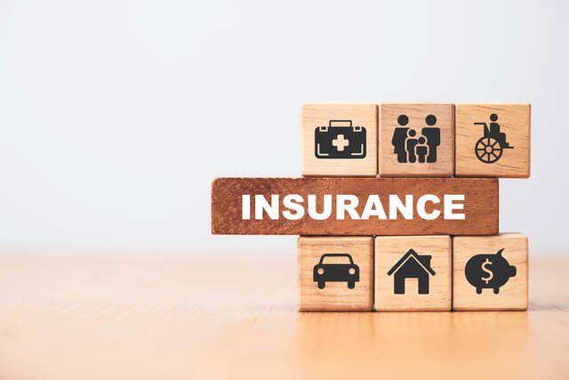 Insurance agent at desk with multi-line coverage icons